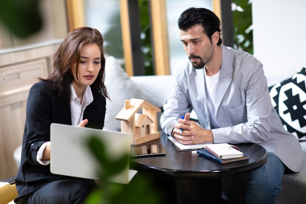 beautiful woman real estate agent offering showing online presentation laptop office handsome man - DSM PROPERTIES