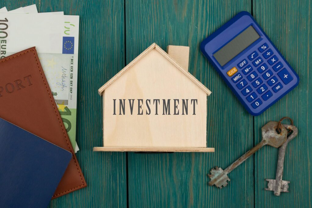 privacy concept little house with text investment keys calculator passport money blue wooden desk 1 - DSM PROPERTIES