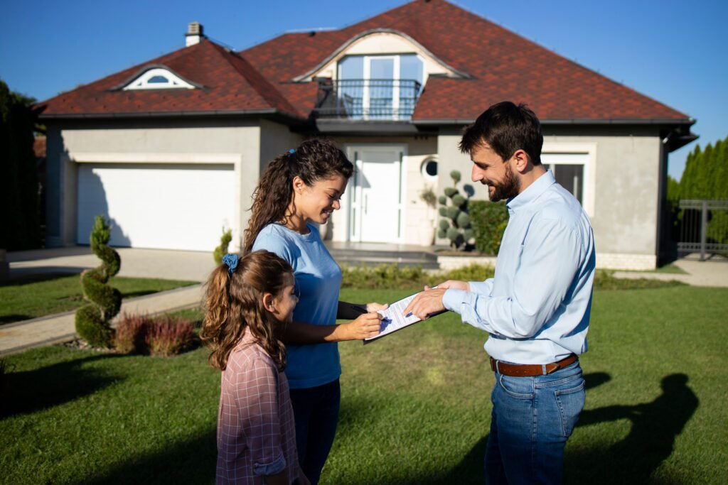 woman signing contract buying new house 1 - DSM PROPERTIES